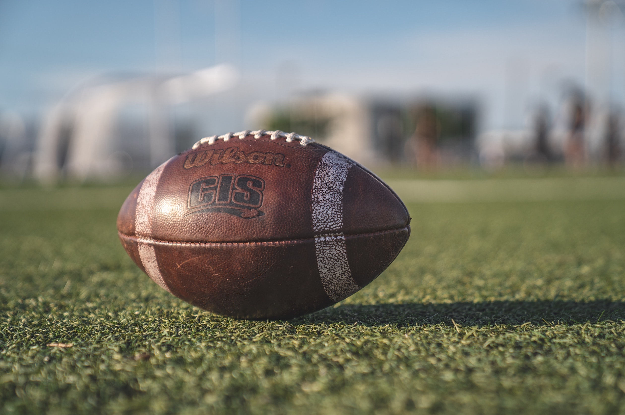 close up of a american football on a field