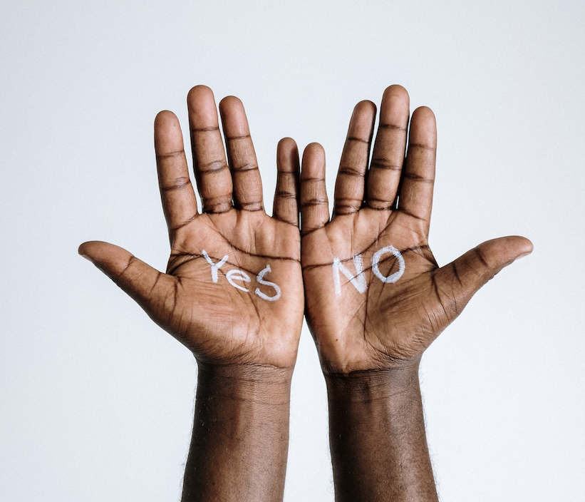 two clack hands with the words "yes," and "no" written on them.