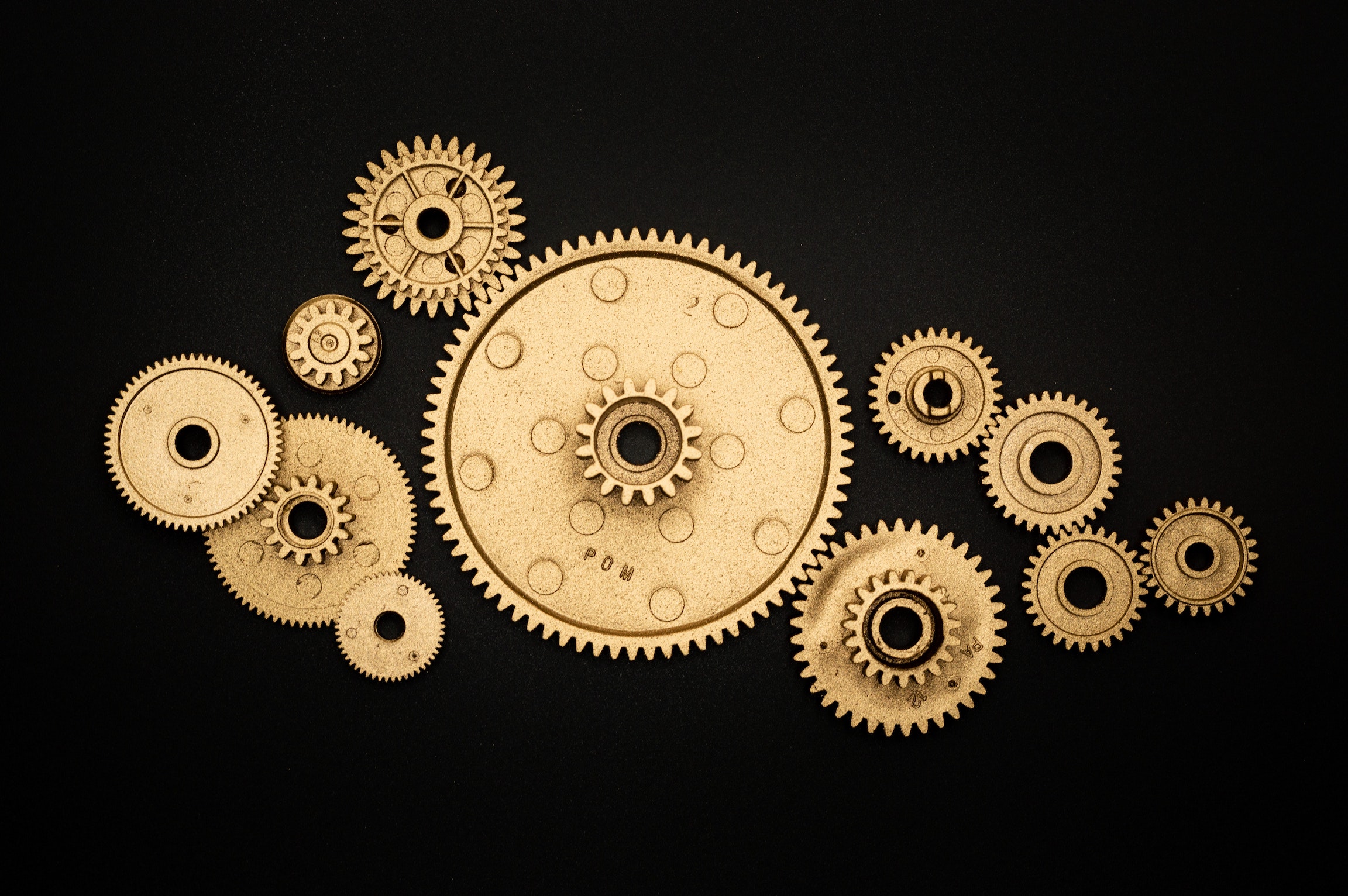 gold gears against a black background