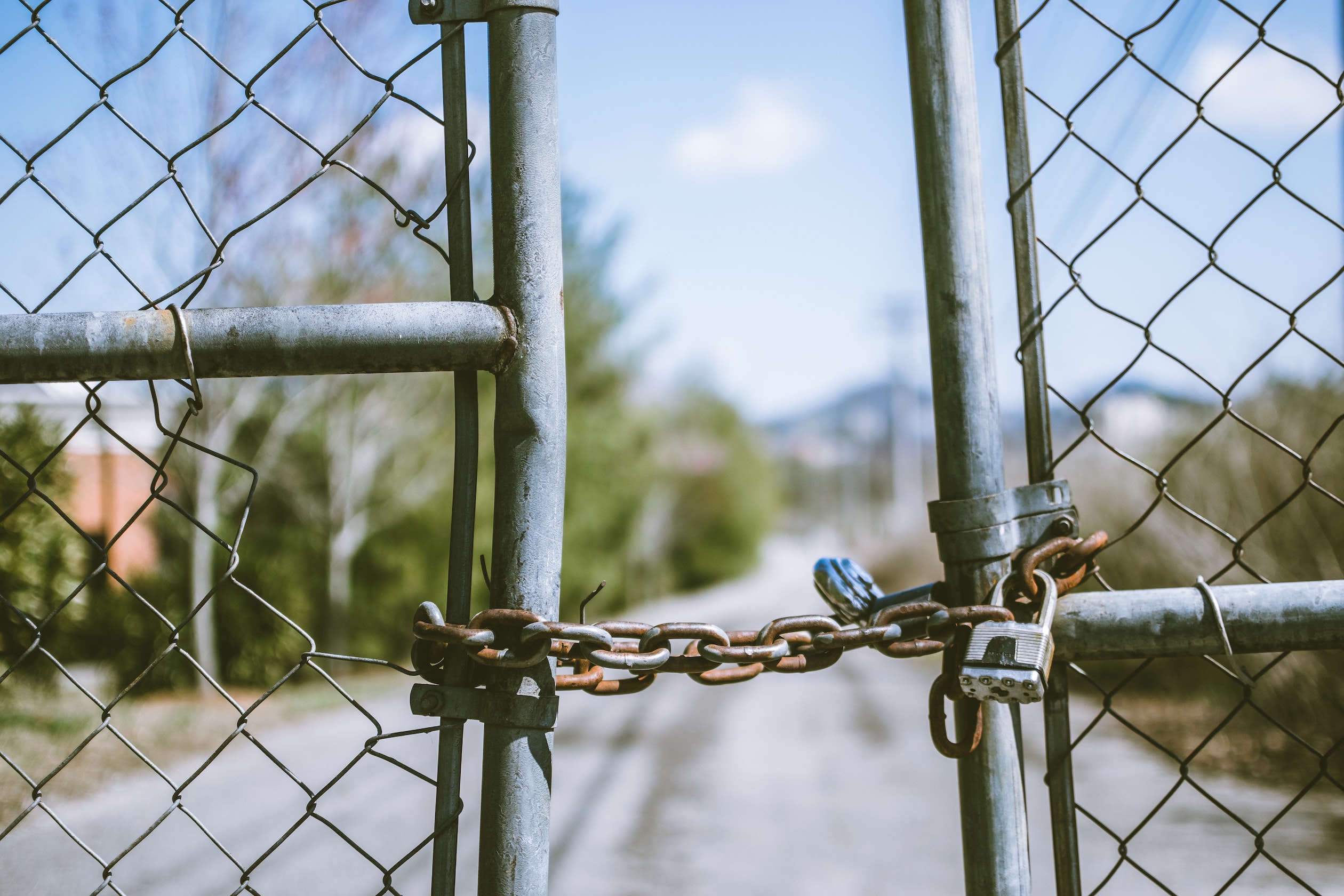 chain link fence with a chained lock around the gate