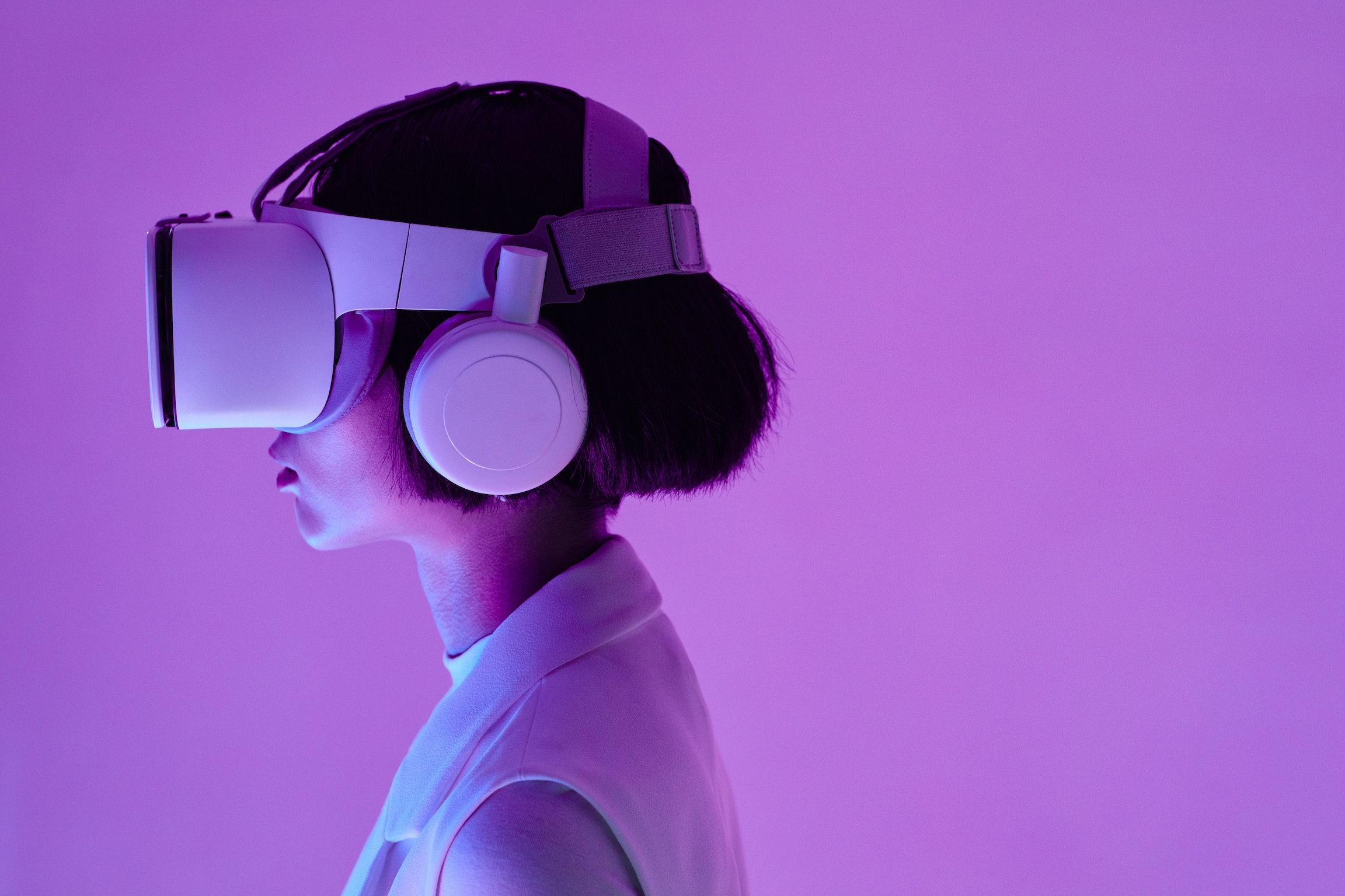 asian woman in VR goggles against a purple background