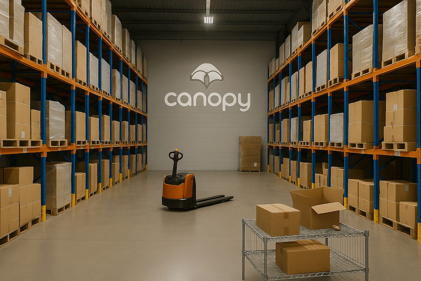 Inventory is stacked on a shelf in an orange ecommerce warehouse.
