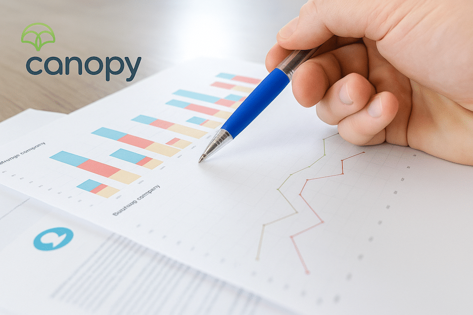 A top down view of documents detailing ecommerce trends with a hand holding a pen making notes on the document