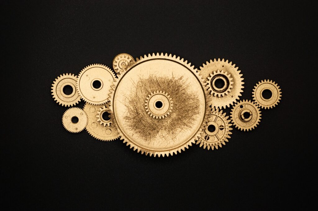 Decorative: Golden cogs turning on a black background.