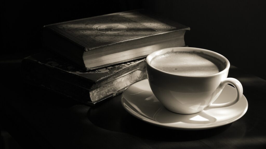 Decorative. Two old books and  a cup of coffee 