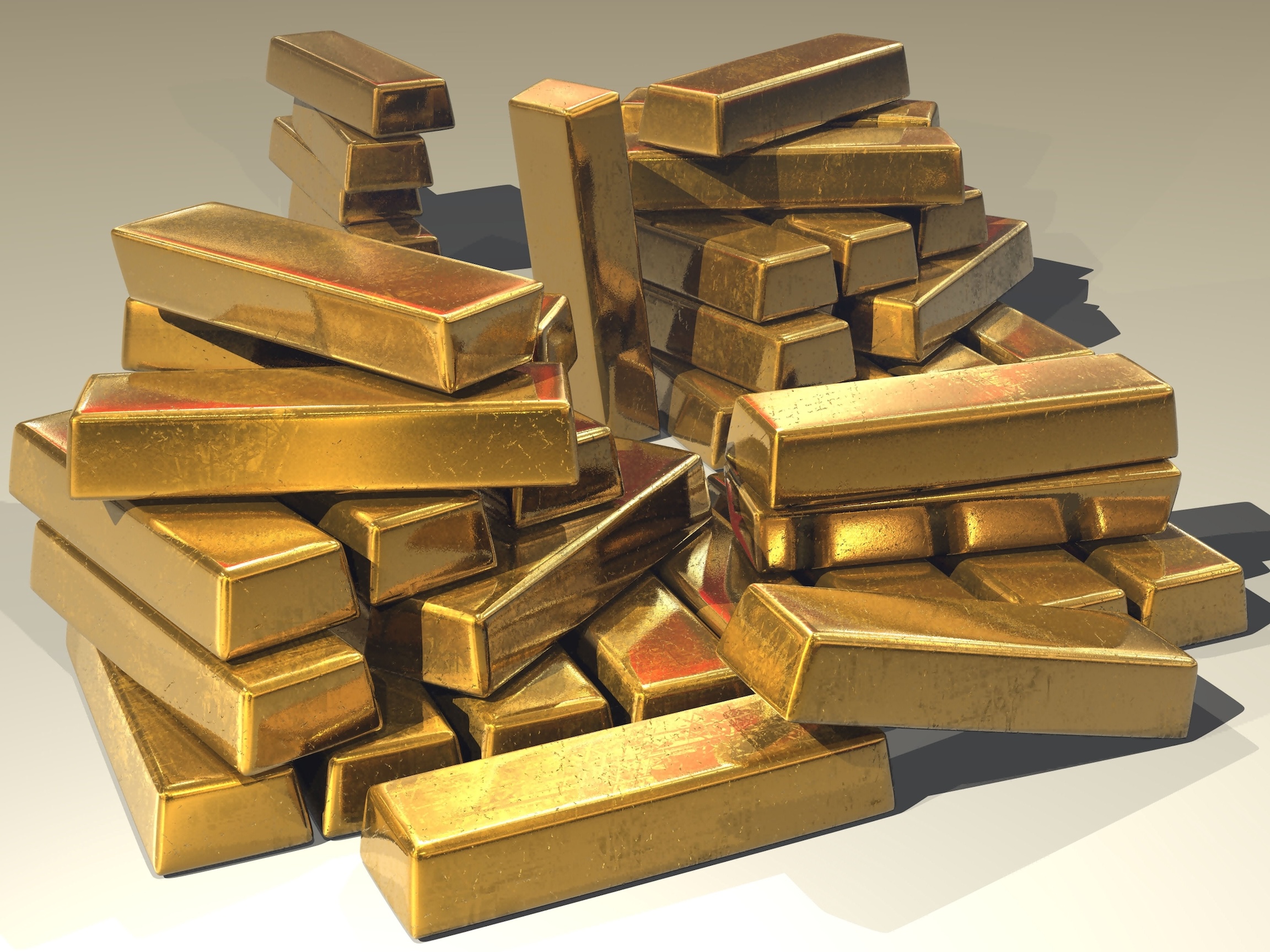 A large pile of golden bars on a white background
