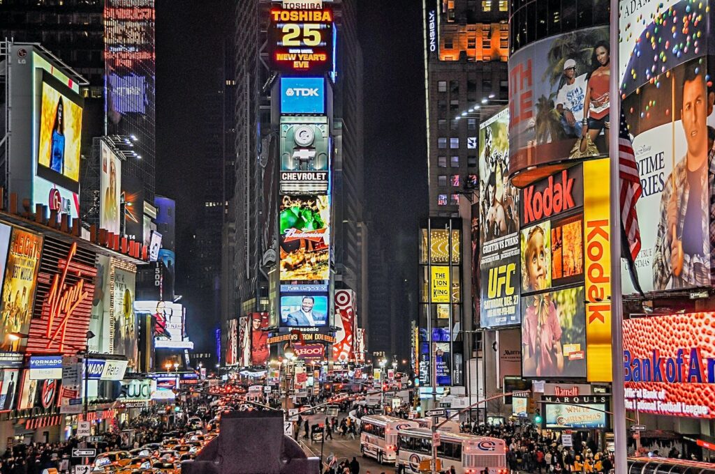 A large vibrant scene of downtown Times Square and the colorful neon advertising 