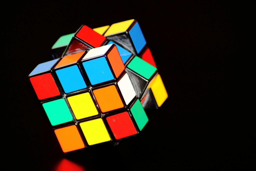 An incomplete Rubic's cube against a black background 