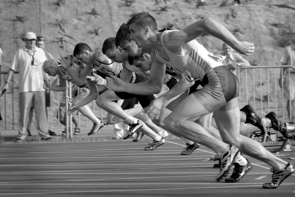 A black and white image of the start of a running race viewed from the side